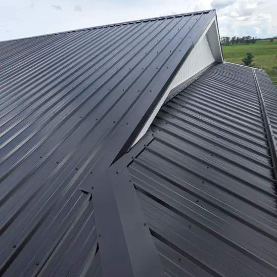 Charcoal metal roofing with gable dormer detail