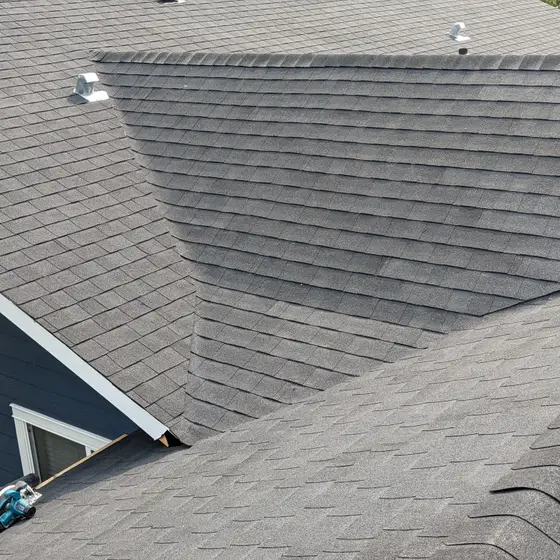 New architectural asphalt shingles across valleys and hips, mid-install
