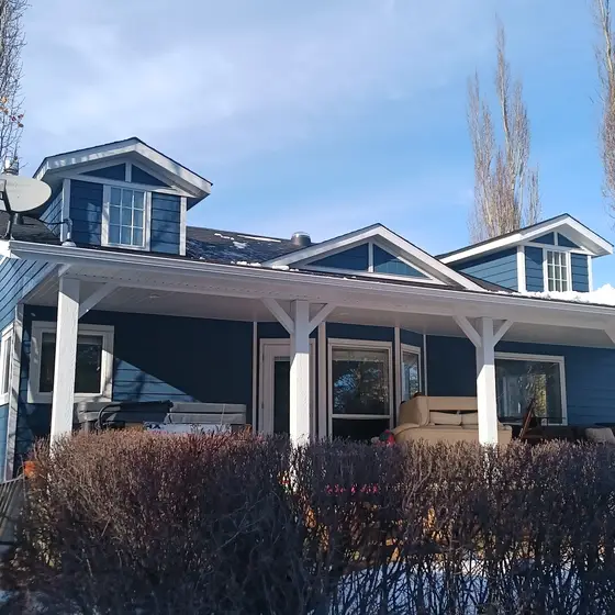 Blue craftsman home with dormers — new roof and siding package