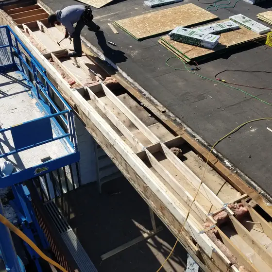 Roof-edge joist and parapet rebuild on a commercial flat roof