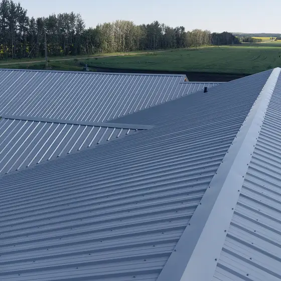 Galvalume standing-seam metal across multiple gables on a Central Alberta acreage