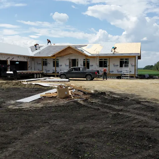 Crew shingling a sprawling new-build bungalow